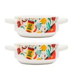 Two Slap Ya Mama ceramic gumbo bowls, each featuring illustrated Slap Ya Mama seasoning cans on the sides, filled with gumbo and garnished with vegetables