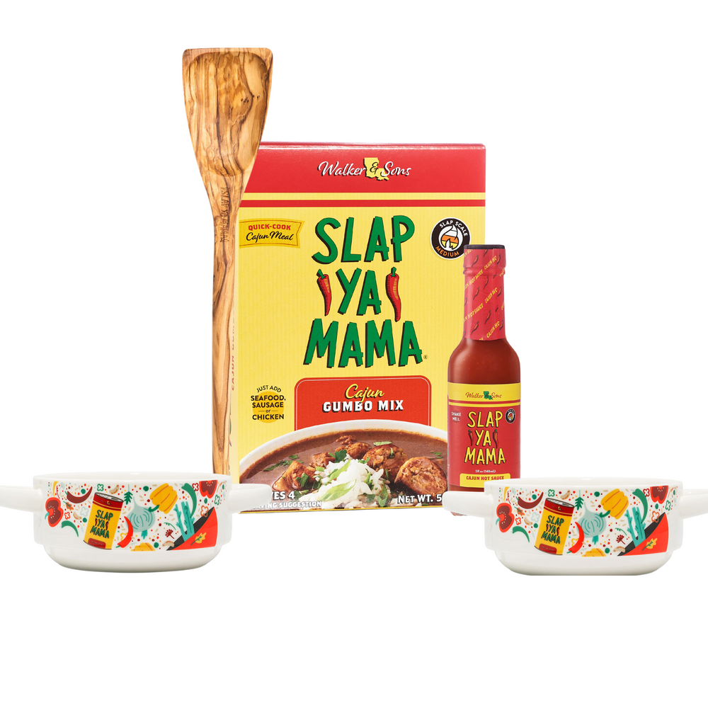 Set includes two Slap Ya Mama gumbo bowls, a package of Slap Ya Mama Gumbo Mix, a bottle of Slap Ya Mama Hot Sauce, and a Slap Ya Mama Roux Spoon, all arranged together on a white background.