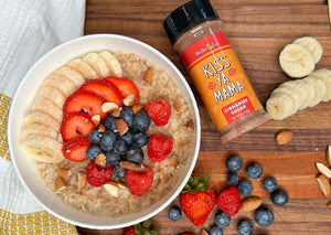 
                  
                    Load image into Gallery viewer, Kiss Ya Mama Cinnamon Sugar canister placed next to a bowl of oatmeal topped with fresh fruit,
                  
                