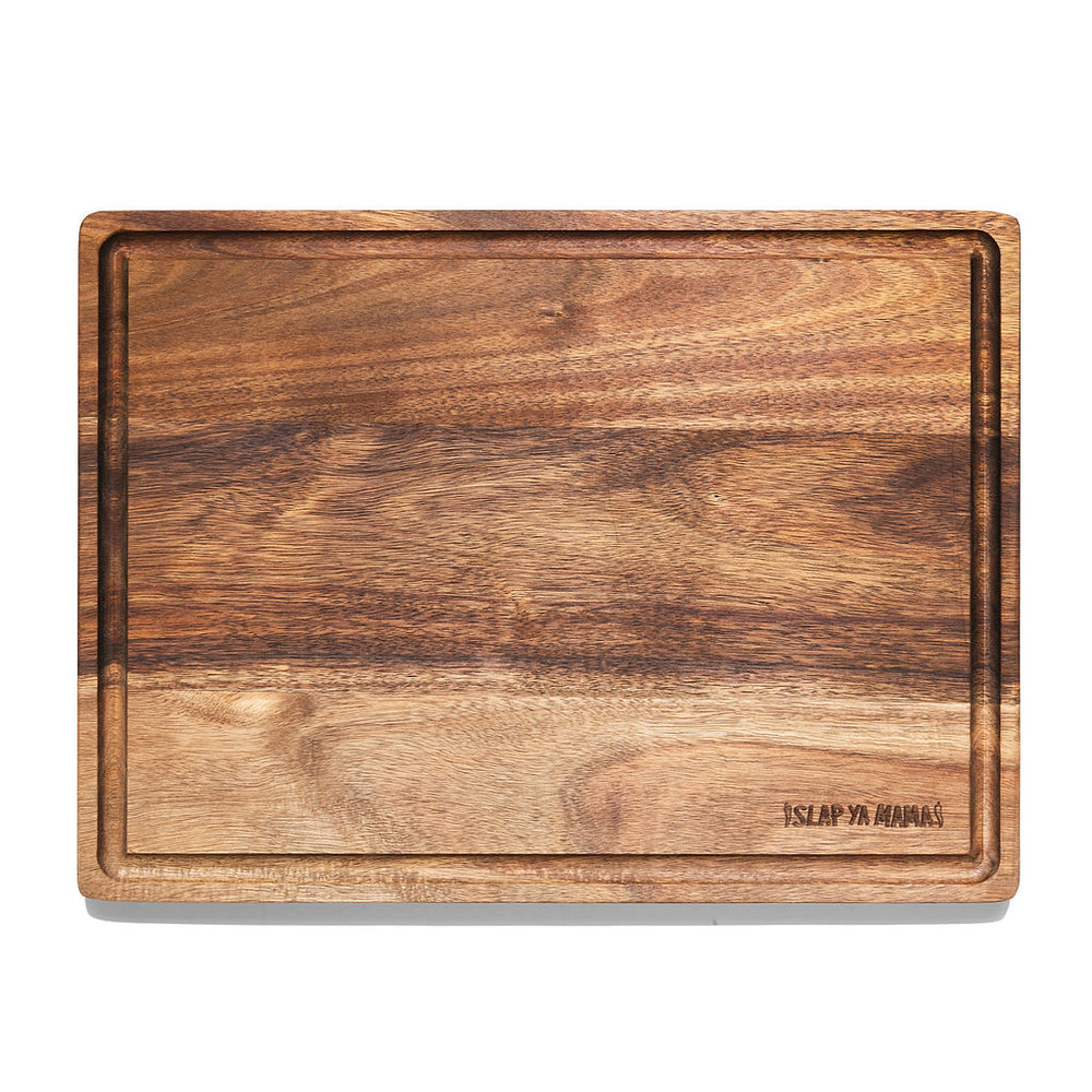 Slap Ya Mama wooden cutting board with the logo engraved in the bottom right corner, displayed on a neutral background.