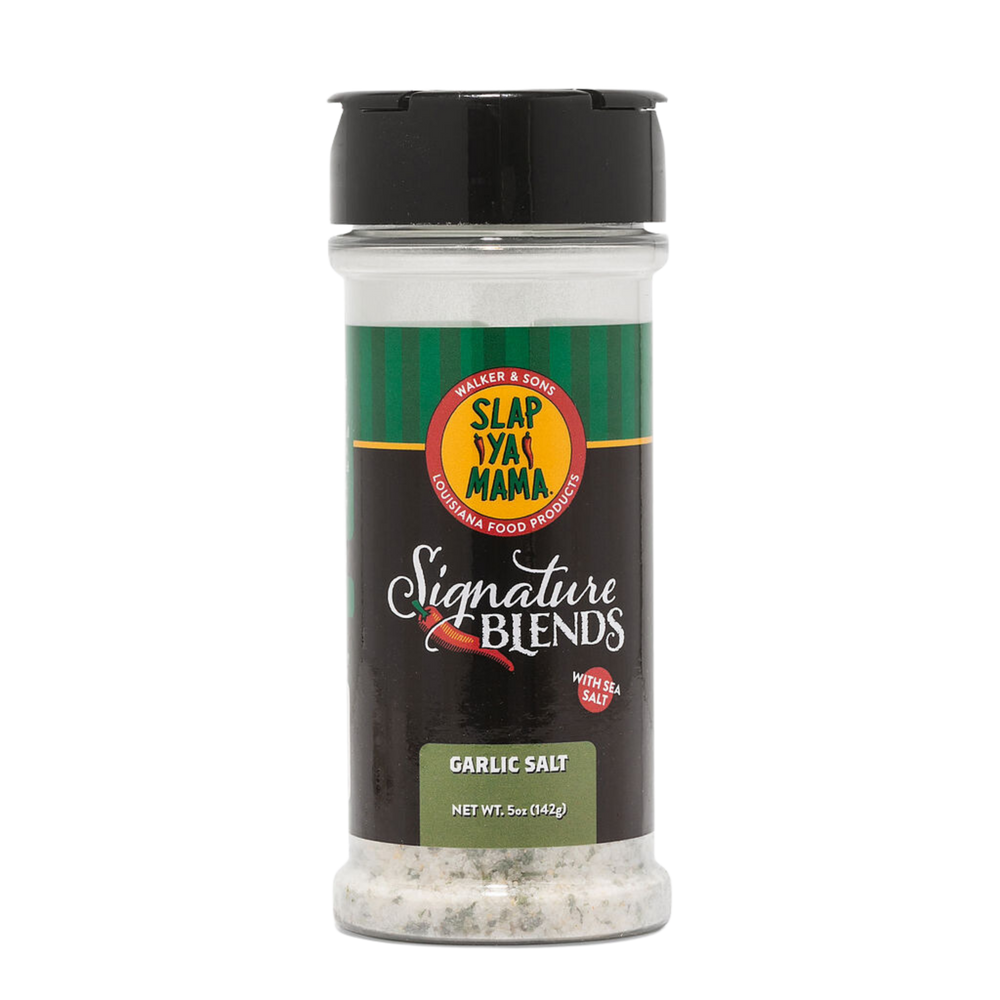 Front of Slap Ya Mama Garlic Salt Signature Blend canister with a black label, featuring the green and yellow Slap Ya Mama logo, text reading 'Garlic Salt Signature Blend,' and a white 'With Sea Salt' call-out in a red bubble.