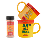 Set includes a Slap Ya Mama mug and a Kiss Ya Mama mug, with the Kiss Ya Mama Cinnamon Sugar shaker placed on the side, with the Kiss Ya Mama mug resting on top of the Slap Ya Mama mug, displayed on a neutral background.