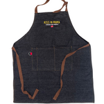 Black denim apron with the yellow Kiss Ya Mama logo embroidered on the chest, with the text 'Louisiana Food Products' in white underneath, and a pepper graphic below that.