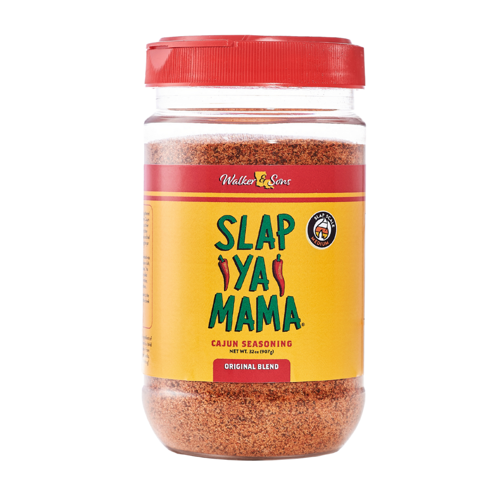 32 oz clear jar of Slap Ya Mama seasoning with a yellow label and green logo, displayed on a neutral background.