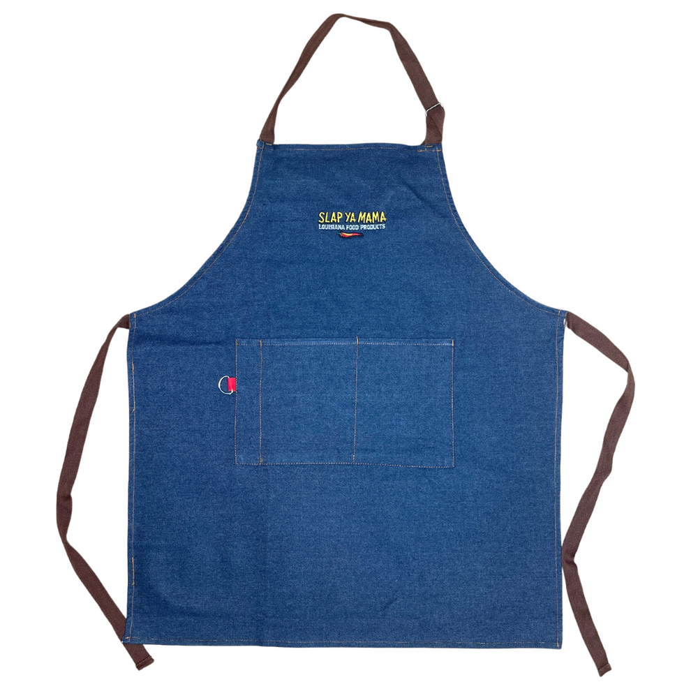 Blue denim apron with the yellow Slap Ya Mama logo embroidered on the chest, with the text 'Louisiana Food Products' in white underneath, and a pepper graphic below that.
