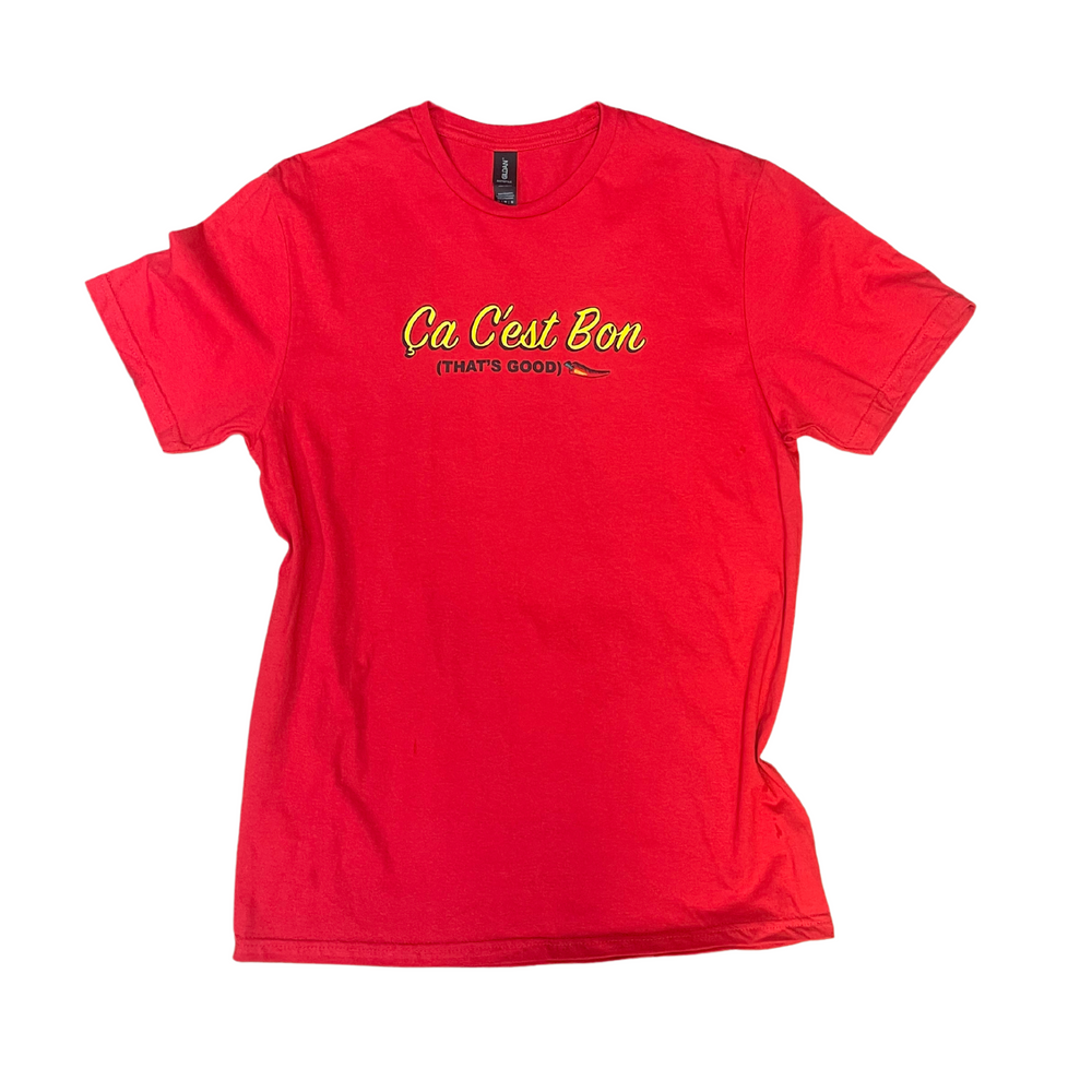  Red Tshirt, reads  Ca Cest Bon in a yellow text, under (That's Good) in black text 