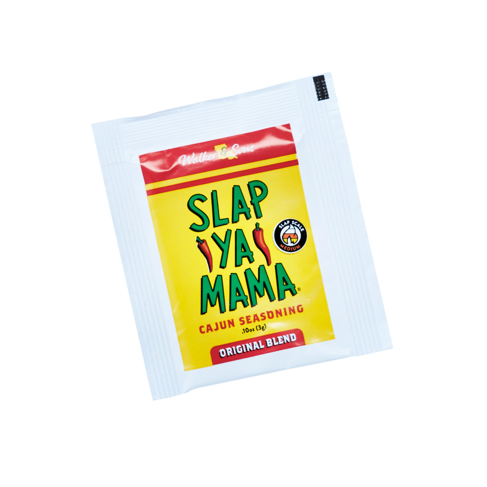 Slap Ya Mama seasoning packet with a yellow label and green logo, displayed on a neutral background.
