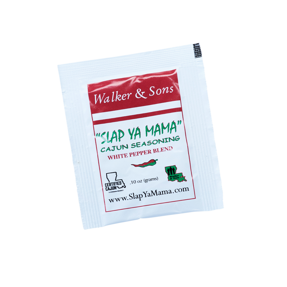 Slap Ya Mama White Pepper Blend seasoning packet with a white label, green logo, and red accents on the label, featuring the text 'White Pepper Blend.