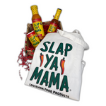 Slap Ya Mama White Cook's Apron, Slap Ya Mama Wing Sauce, 4oz Original Blend Cajun Seasoning, and 5oz Cajun Pepper Sauce arranged in a basket with pepper designs, and red crinkle paper.